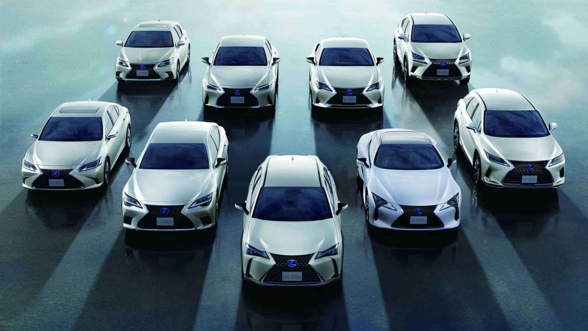 Lexus Electrified global vehicle line-up - 8 Lexus electrified vehicles are lined up in a V formation in two rows, one behind the other.
