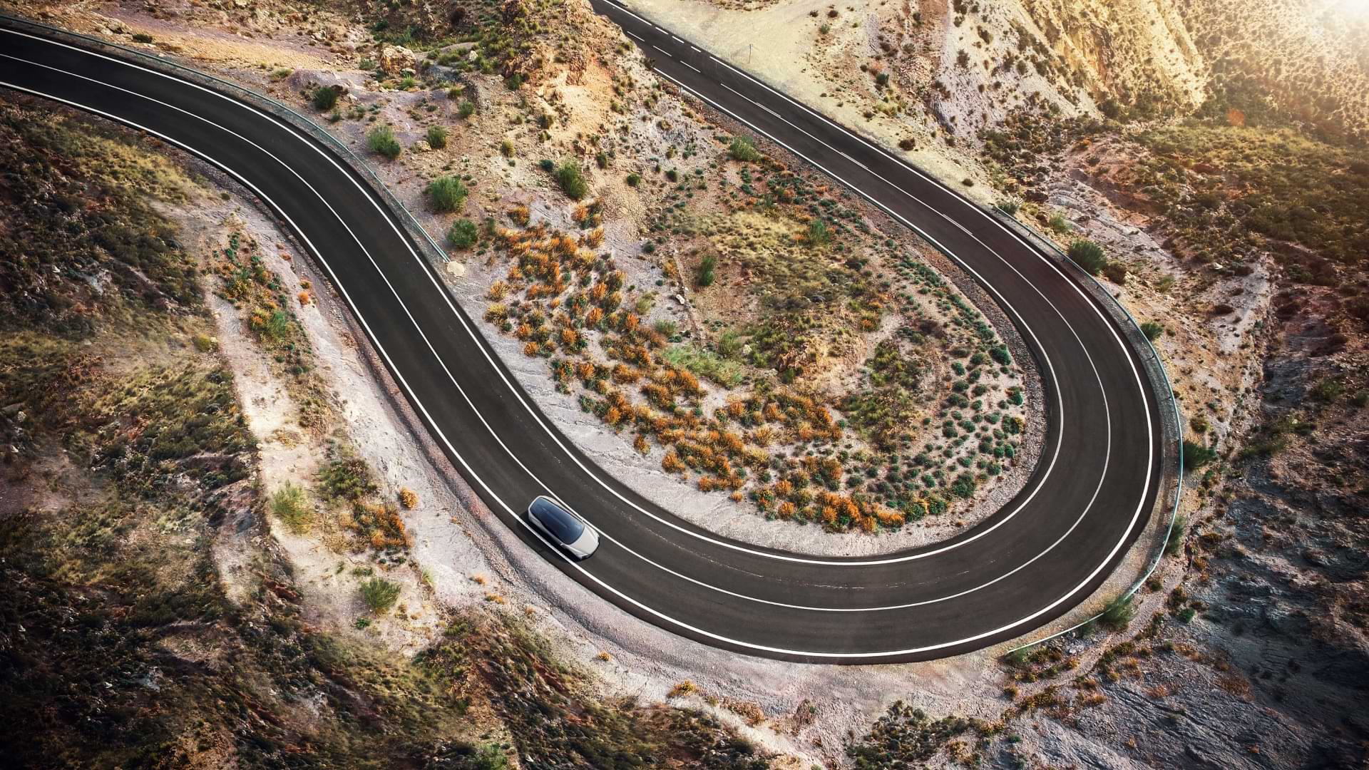 A Lexus LF-Z drives along a winding road.